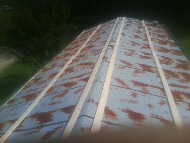 Rusted metal roof panels with new wood purlins before replacement — Storm Damage Roof Repair in Walterville by Roofing Brothers